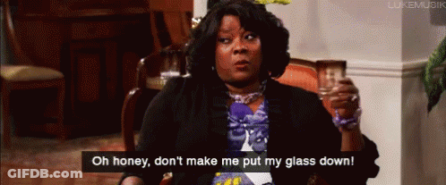 A Woman Is Sitting In A Chair Holding A Glass And Saying Oh Honey , Don 'T Make Me Put My Glass Down GIF