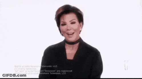 A Woman Is Sitting In A Chair Holding A Tissue To Her Face . GIF