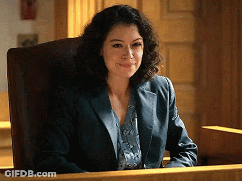 Woman Sitting In Courtroom Smiling GIF