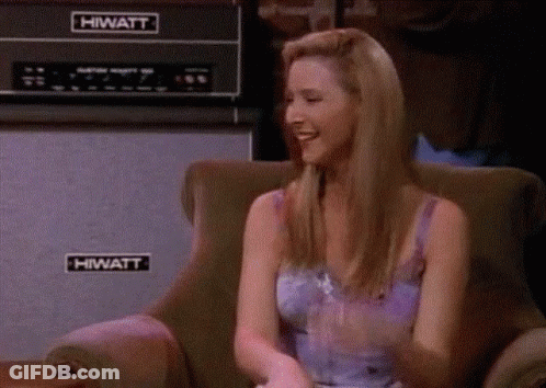 A Woman Is Sitting In A Chair In Front Of A Hiwatt Amplifier . GIF