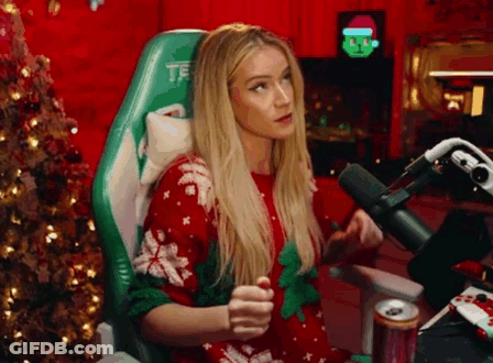 A Woman Is Sitting In A Chair In Front Of A Microphone . GIF