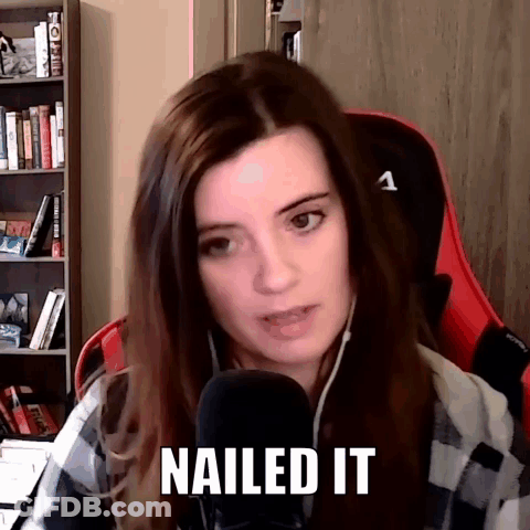 A Woman Is Sitting In A Chair In Front Of A Microphone With The Words Nailed It Written On Her Face . GIF