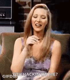A Woman Is Sitting In A Chair Laughing And Saying `` You Hackin ' On Me '' . GIF
