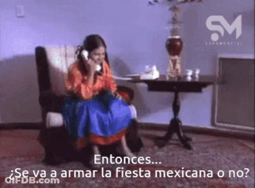 A Woman Is Sitting In A Chair Talking On A Phone With The Words Entonces Written Below Her GIF