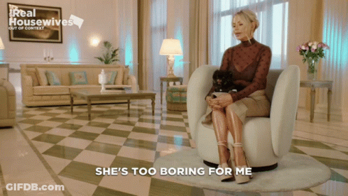 A Woman Is Sitting In A Chair With A Dog And The Words She 'S Too Boring For Me Behind Her GIF