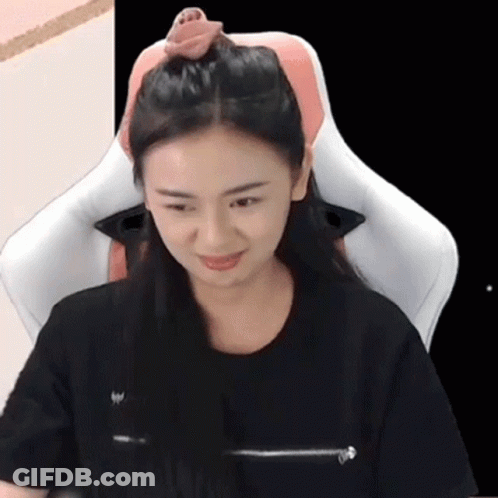 Woman Sitting With Pink Pillow On Her Head GIF