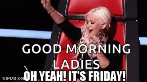 A Woman Is Sitting In A Chair With Her Arms In The Air And Singing A Song . GIF