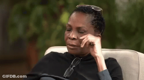 A Woman Is Sitting In A Chair With Her Eyes Closed And The Word Lord Written On The Screen . GIF