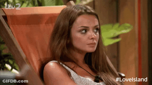 A Woman Is Sitting In A Chair With Her Eyes Closed . GIF