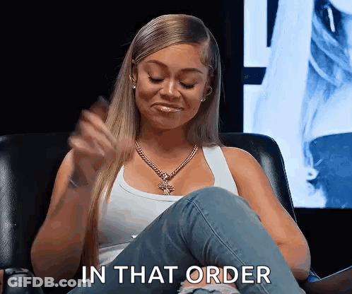 A Woman Is Sitting In A Chair With Her Legs Crossed And Says In That Order . GIF
