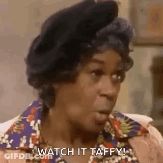 A Woman Is Sitting In A Chair With Her Mouth Open And Says `` Watch It Taffy ! '' GIF