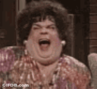 A Woman Is Sitting In A Chair With Her Mouth Open . GIF