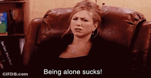 A Woman Is Sitting In A Chair With The Words `` Being Alone Sucks '' Written On The Bottom . GIF