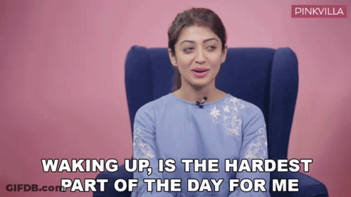 A Woman Is Sitting In A Chair With The Words Waking Up Is The Hardest Part Of The Day For Me Written Below Her GIF