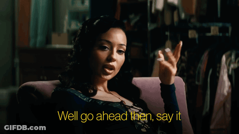 A Woman Is Sitting In A Chair With The Words Well Go Ahead Then Say It GIF
