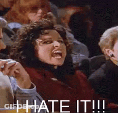 A Woman Is Sitting In A Crowd Of People With Her Mouth Open And The Words `` I Hate It ! '' GIF