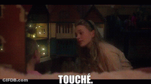 A Woman Is Sitting In A Dark Room Looking Out A Window And The Words `` Touche '' Are Above Her . GIF