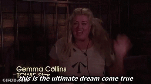 A Woman Is Sitting In A Dark Room With Her Hands In The Air . GIF