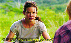 A Woman Is Sitting In A Field Talking To A Man And Says What Did You Just Say ? GIF