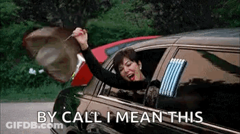 A Woman Is Sitting In A Limousine With Her Arms In The Air And Holding A Key . GIF