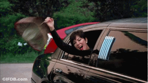 A Woman Is Sitting In A Limousine With Her Arms Out The Window And Holding An Umbrella . GIF