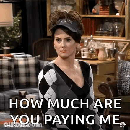 A Woman Is Sitting In A Living Room Wearing A Hat And A Sweater And Says `` How Much Are You Paying Me '' GIF