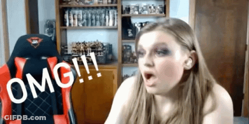 A Woman Is Sitting In A Red And Black Chair With The Word Omg Written On It GIF