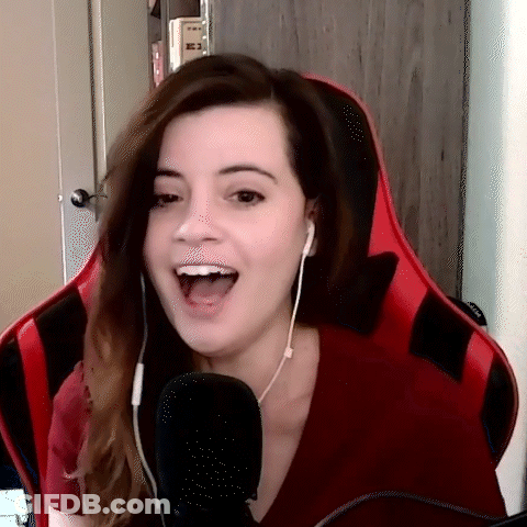 A Woman Is Sitting In A Red Chair With Her Mouth Open GIF