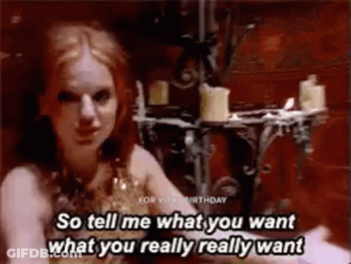 A Woman Is Sitting In A Room With Candles And Says `` So Tell Me What You Want What You Really Really Want '' GIF