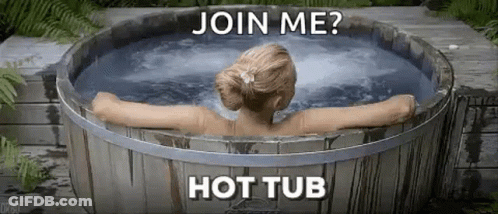 A Woman Is Sitting In A Wooden Hot Tub With The Words `` Join Me ? Hot Tub '' . GIF