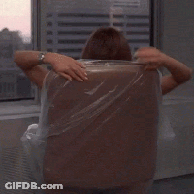 A Woman Is Sitting In An Office Chair With Her Legs Crossed And Holding A Plastic Bag . GIF