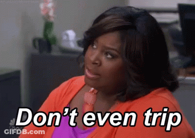 A Woman Is Sitting In An Office With The Words `` Don 'T Even Trip '' Written On The Screen . GIF