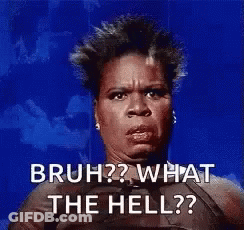 A Woman Is Sitting In Front Of A Blue Background And Making A Funny Face . GIF