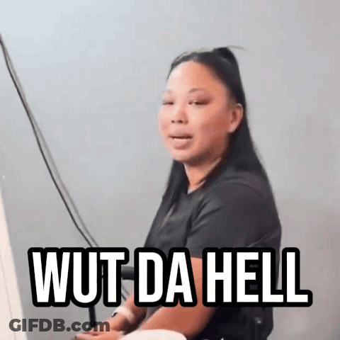 A Woman Is Sitting In Front Of A Computer With The Words Wut Da Hell Written On Her Face GIF