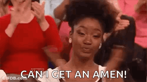 A Woman Is Sitting In Front Of A Crowd Of People And Making A Face . GIF