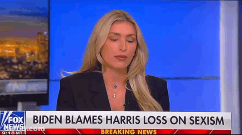 A Woman Is Sitting In Front Of A Fox News Breaking News Sign . GIF