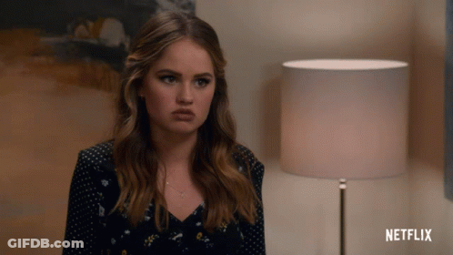A Woman Is Sitting In Front Of A Lamp And A Netflix Logo GIF