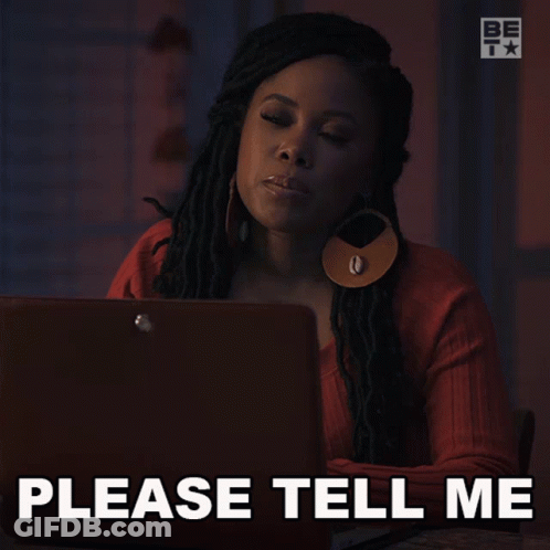 A Woman Is Sitting In Front Of A Laptop With The Words Please Tell Me Below Her GIF