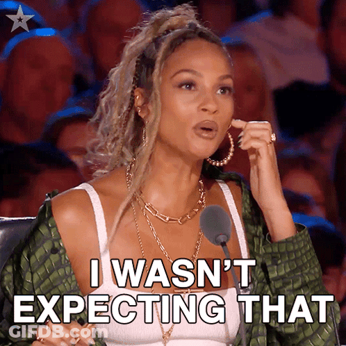 A Woman Is Sitting In Front Of A Microphone And Says I Wasn 'T Expecting That GIF