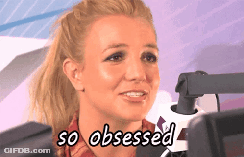 A Woman Is Sitting In Front Of A Microphone And Says " So Obsessed " GIF
