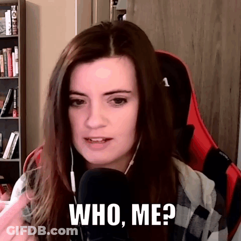 A Woman Is Sitting In Front Of A Microphone And Says Who Me GIF
