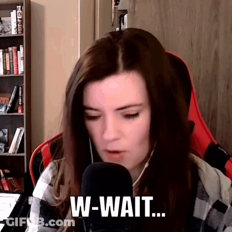 A Woman Is Sitting In Front Of A Microphone And Talking Into It While Wearing Headphones . GIF