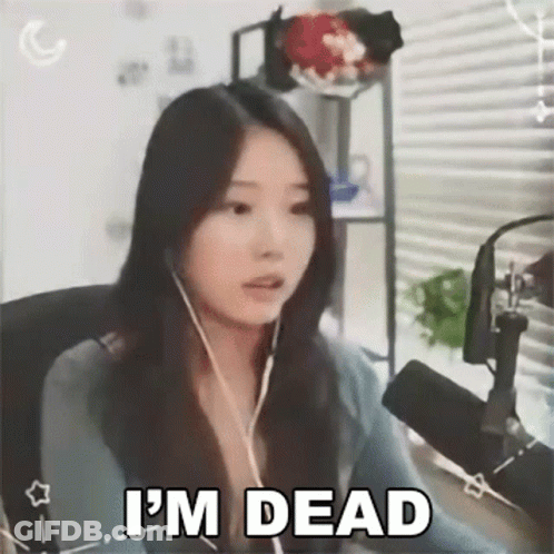 A Woman Is Sitting In Front Of A Microphone While Wearing Headphones And Says `` I 'M Dead '' . GIF