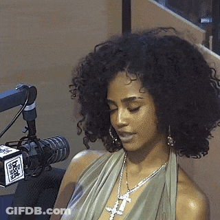 A Woman Is Sitting In Front Of A Microphone With A Box That Says Fox GIF