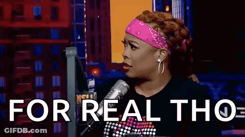 A Woman Is Sitting In Front Of A Microphone With The Words `` For Real Tho '' Written On The Screen . GIF