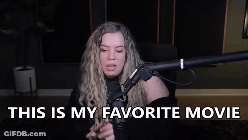 A Woman Is Sitting In Front Of A Microphone With The Words `` This Is My Favorite Movie '' Written Above Her . GIF