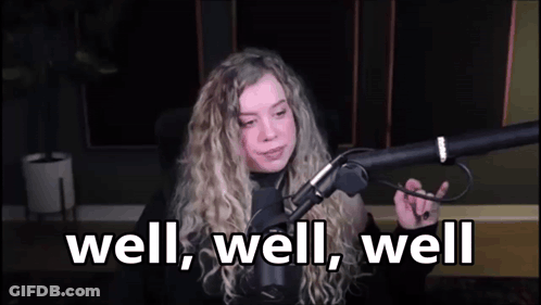A Woman Is Sitting In Front Of A Microphone With The Words `` Well , Well , Well '' . GIF