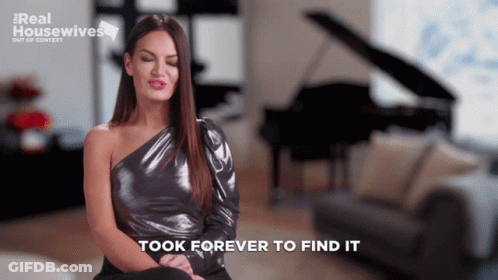 A Woman Is Sitting In Front Of A Piano And The Words Took Forever To Find It Are Next To Her GIF