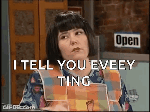 A Woman Is Sitting In Front Of A Sign That Says Open GIF