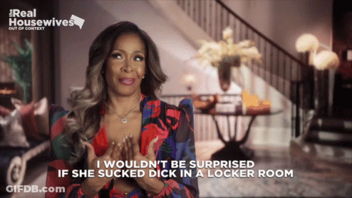 A Woman Is Sitting In Front Of A Sign That Says ' Real Housewives ' On It GIF